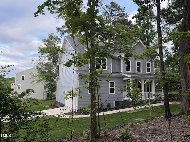 509 Olive Branch Rd, Durham, NC 27703 - view of side of home featuring a porch, a yard, and a garage