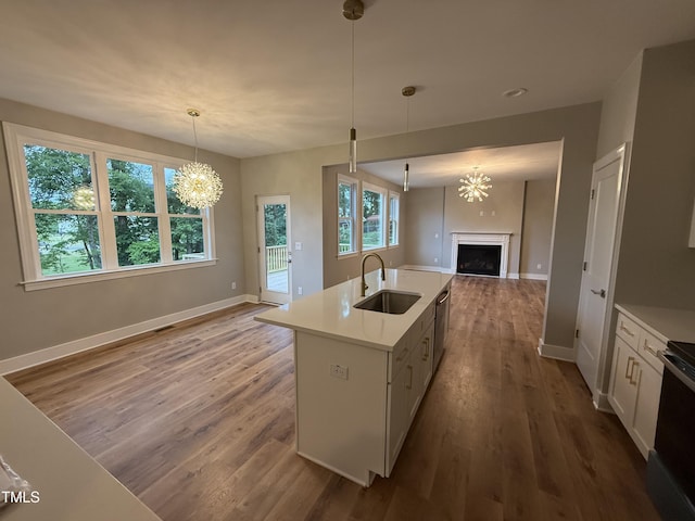509 Olive Branch Rd, Durham, NC 27703 - kitchen featuring a sink, open floor plan, a fireplace, wood finished floors, and baseboards