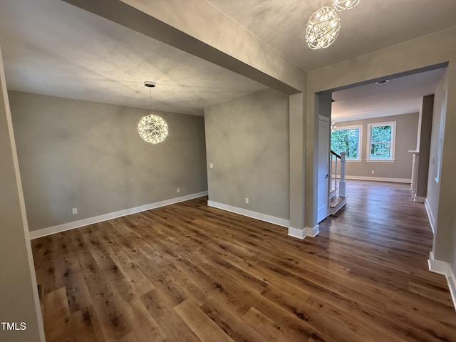 509 Olive Branch Rd, Durham, NC 27703 - unfurnished room featuring a chandelier, dark wood finished floors, and baseboards