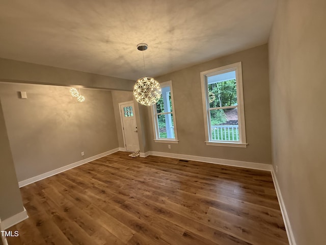 509 Olive Branch Rd, Durham, NC 27703 - unfurnished dining area featuring a chandelier, wood finished floors, and baseboards