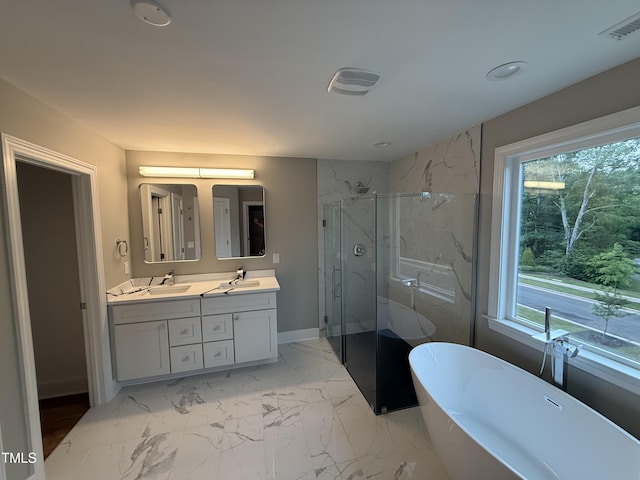 509 Olive Branch Rd, Durham, NC 27703 - full bathroom featuring double vanity, a marble finish shower, a freestanding tub, marble finish flooring, and baseboards