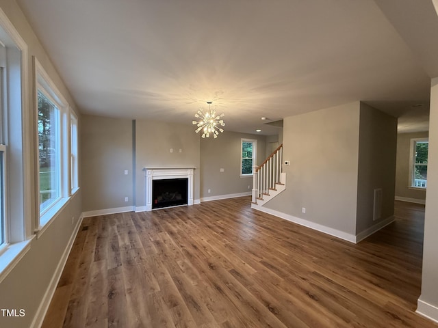 509 Olive Branch Rd, Durham, NC 27703 - unfurnished living room with wood finished floors, baseboards, and plenty of natural light