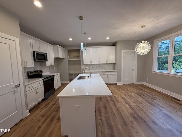 509 Olive Branch Rd, Durham, NC 27703 - kitchen featuring electric range oven, stainless steel microwave, a sink, baseboards, and light countertops