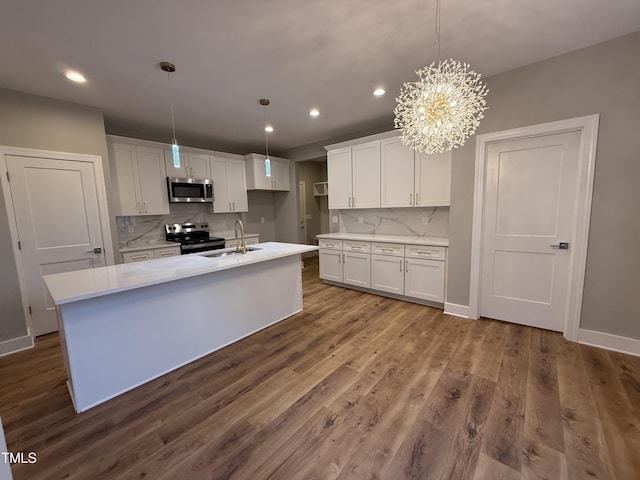 509 Olive Branch Rd, Durham, NC 27703 - kitchen featuring appliances with stainless steel finishes, recessed lighting, light countertops, white cabinetry, and backsplash