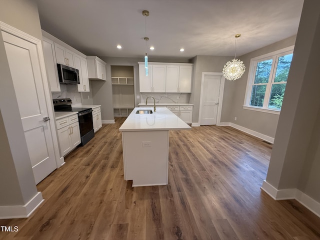 509 Olive Branch Rd, Durham, NC 27703 - kitchen featuring black range with electric cooktop, stainless steel microwave, a sink, baseboards, and recessed lighting