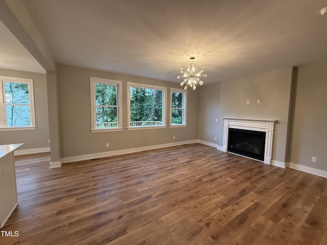 509 Olive Branch Rd, Durham, NC 27703 - unfurnished living room with a chandelier, a fireplace, dark wood-style floors, and baseboards