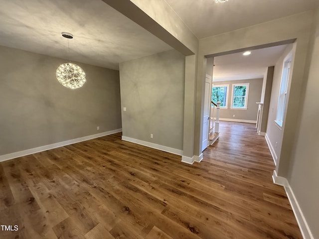 509 Olive Branch Rd, Durham, NC 27703 - empty room with dark wood-style flooring, baseboards, and a chandelier
