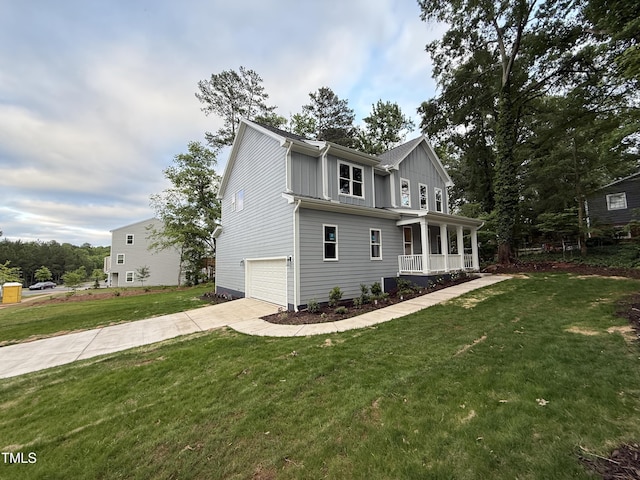 509 Olive Branch Rd, Durham, NC 27703 - view of front of house with a porch, a garage, concrete driveway, and a front lawn