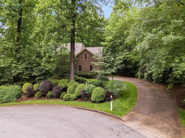 view of front of home featuring brick siding and driveway