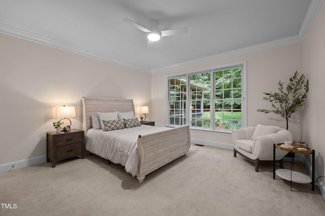 bedroom with baseboards, ornamental molding, light carpet, and a ceiling fan