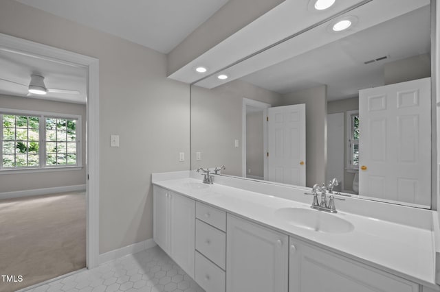 full bathroom with toilet, baseboards, double vanity, tile patterned floors, and recessed lighting