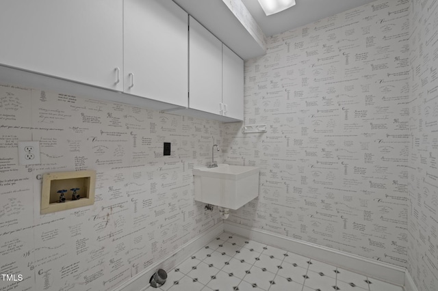 bathroom with baseboards and a sink
