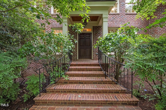 entrance to property featuring brick siding