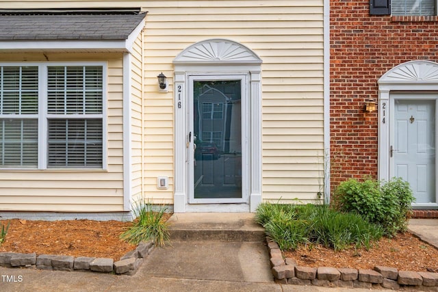doorway to property featuring brick siding
