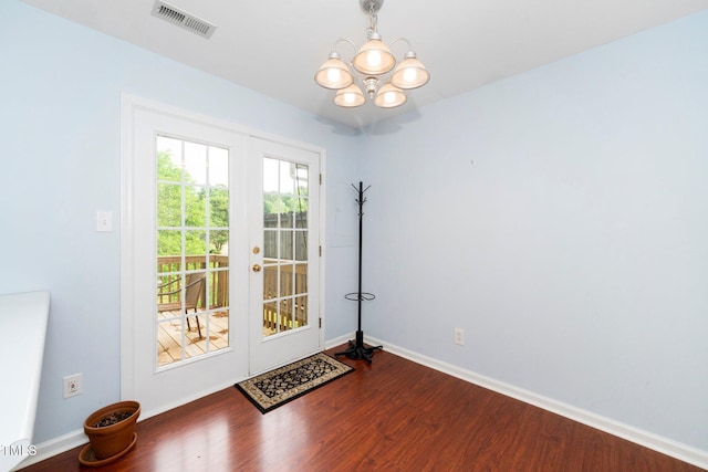 doorway to outside featuring a chandelier, dark wood-style flooring, french doors, and baseboards