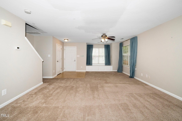 carpeted spare room featuring a ceiling fan, baseboards, and a smoke detector