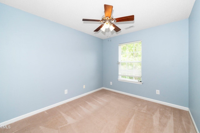 empty room with baseboards, light colored carpet, and ceiling fan
