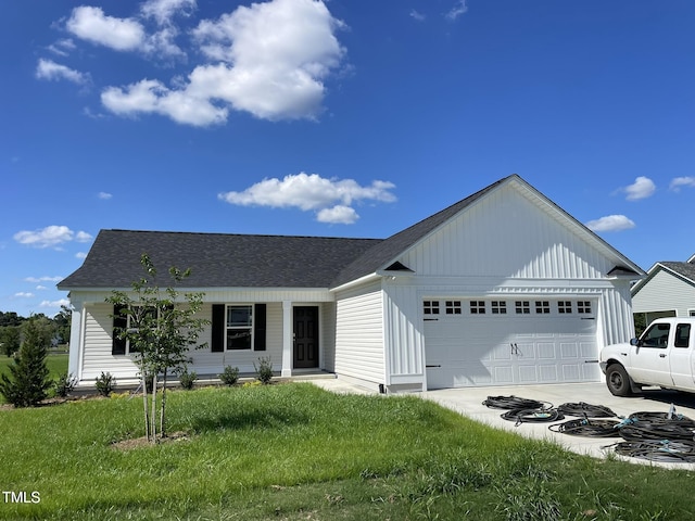 ranch-style home featuring covered porch, an attached garage, concrete driveway, roof with shingles, and a front lawn