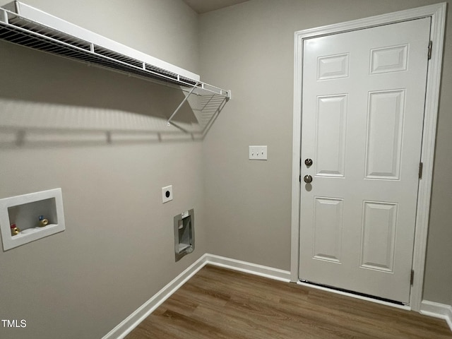 clothes washing area featuring baseboards, dark wood-style flooring, hookup for a washing machine, laundry area, and electric dryer hookup