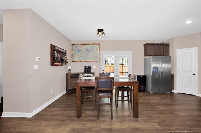dining space featuring baseboards and dark wood-type flooring