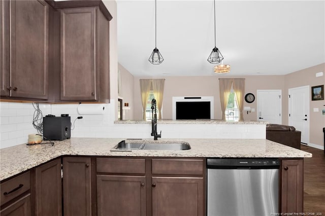 kitchen with a sink, decorative backsplash, open floor plan, and dishwasher