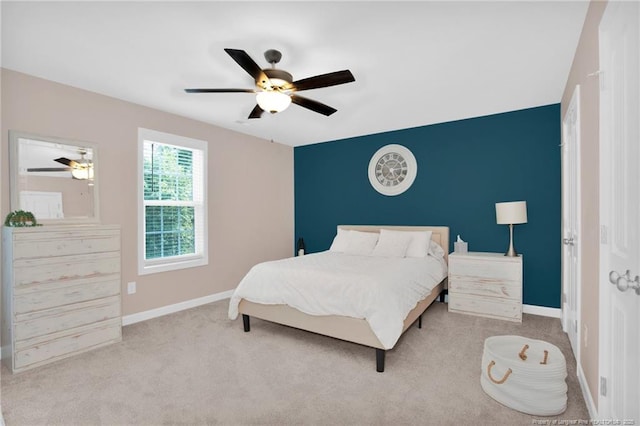 carpeted bedroom with baseboards and a ceiling fan