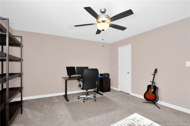 carpeted home office featuring ceiling fan and baseboards