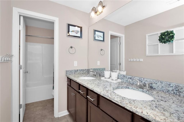 full bath featuring tile patterned floors, double vanity, visible vents, and a sink