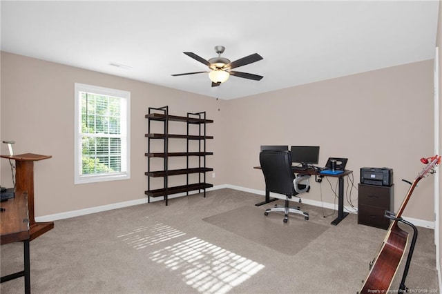 office space featuring visible vents, baseboards, ceiling fan, and carpet floors