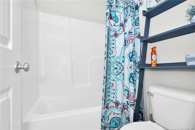bathroom with toilet and shower / tub combo with curtain