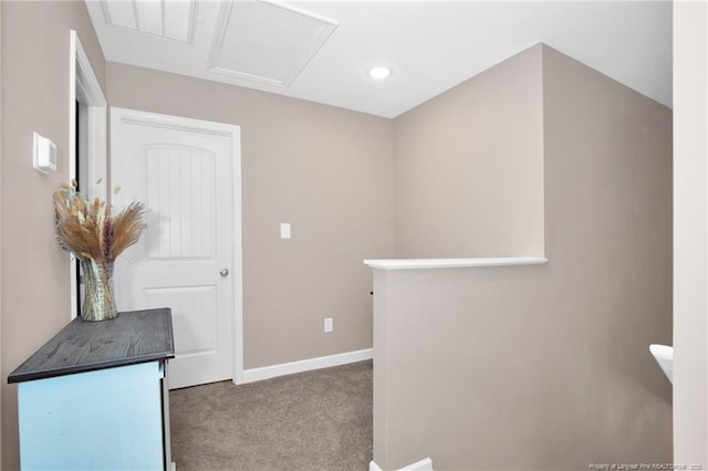 hall with attic access, recessed lighting, baseboards, an upstairs landing, and carpet floors