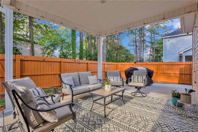 view of patio / terrace featuring an outdoor living space, grilling area, and a fenced backyard