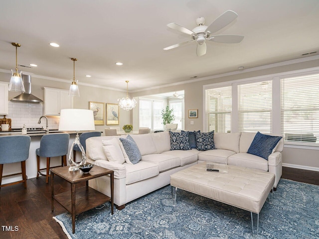 living room featuring ceiling fan, healthy amount of natural light, dark wood finished floors, crown molding, and recessed lighting