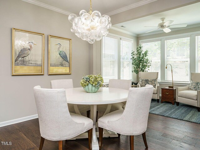 dining room featuring dark wood finished floors, a chandelier, baseboards, crown molding, and ceiling fan