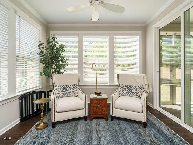 sunroom / solarium featuring wood finished floors, healthy amount of natural light, baseboards, and ornamental molding