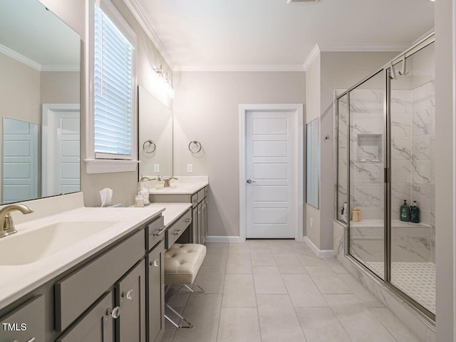 full bathroom featuring a marble finish shower, ornamental molding, baseboards, two vanities, and tile patterned flooring