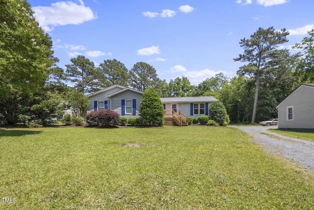 view of front facade with a front lawn and driveway