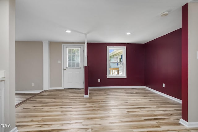 empty room with light wood finished floors, baseboards, and recessed lighting
