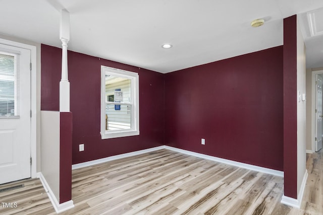 foyer entrance featuring light wood-style flooring and baseboards