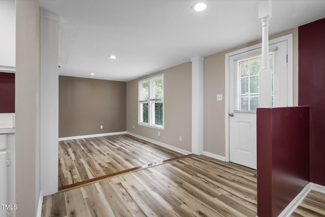 entrance foyer with wood finished floors, baseboards, recessed lighting, and decorative columns