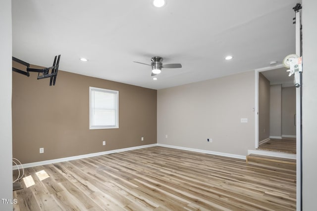 spare room with baseboards, recessed lighting, ceiling fan, and light wood-style flooring