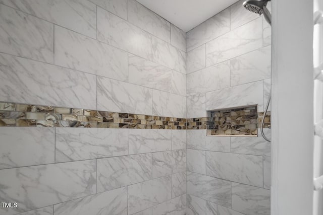 full bath featuring a tile shower