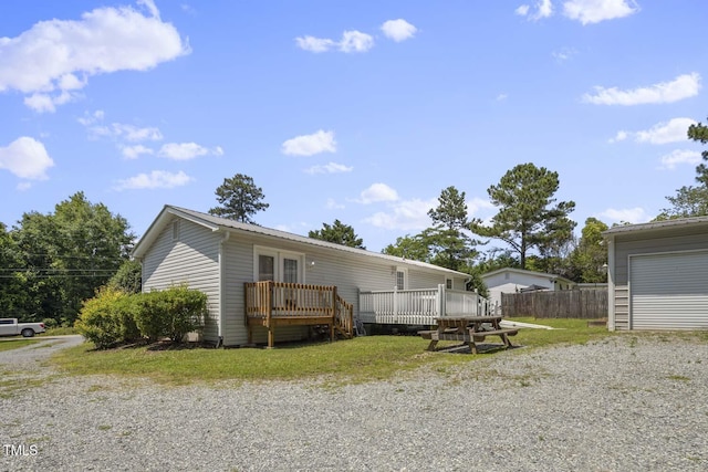 view of front of property featuring a wooden deck and fence