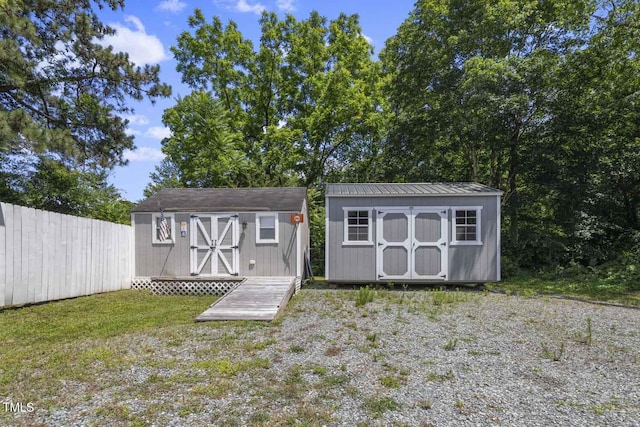 view of shed featuring fence