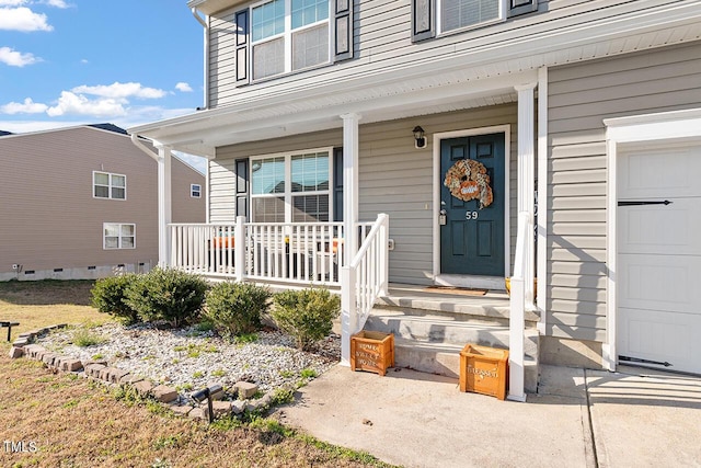 doorway to property with covered porch and a garage
