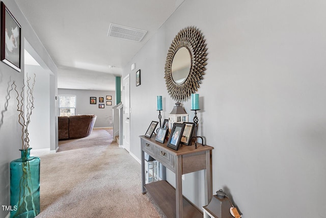 hallway with carpet floors and baseboards