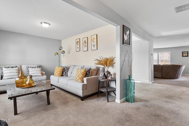 living room featuring carpet flooring and baseboards