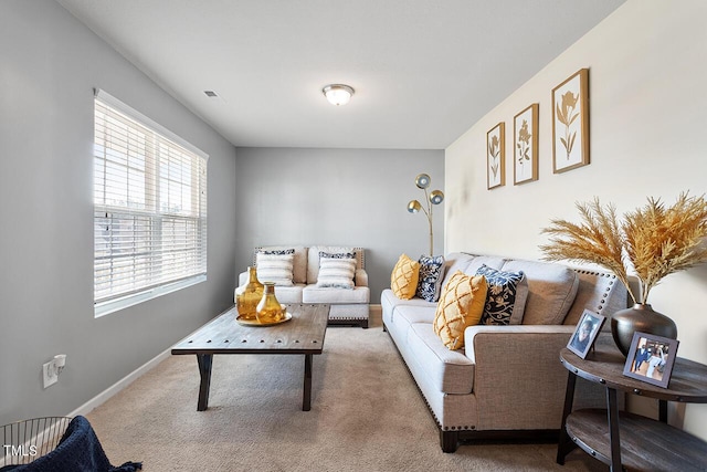 carpeted living room featuring baseboards