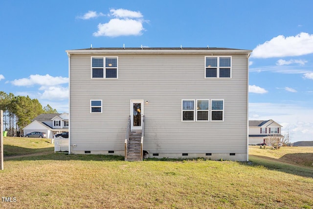 rear view of house featuring crawl space and a lawn