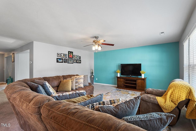 living room featuring carpet floors, ceiling fan, and baseboards